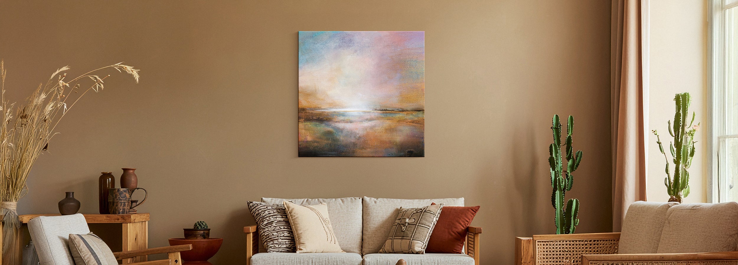 Warm and earthy living room with golden tones, natural textures, and canvas wall art