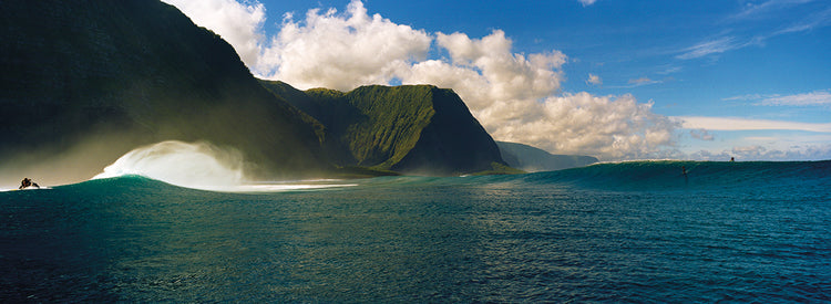 Rolling waves with mountains in the background, Molokai,Hawaii