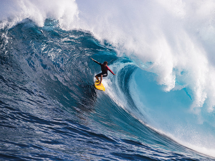 Male surfer surfing wave in Pacific Ocean, Peahi,Hawaii,USA 2