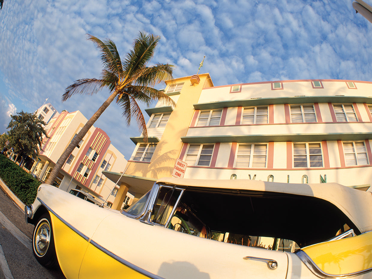 Car on the road with a building in the background, Miami Beach, Miami-Dade County, Florida, USA