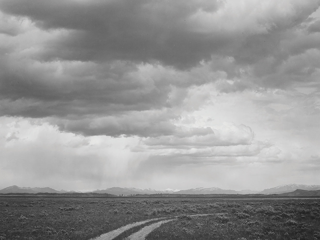 Near Grand Teton National Park, Roadway, Low Horizon Mountains, Clouded Sk