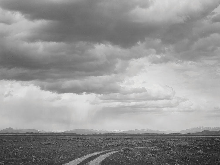 Near Grand Teton National Park, Roadway, Low Horizon Mountains, Clouded Sk